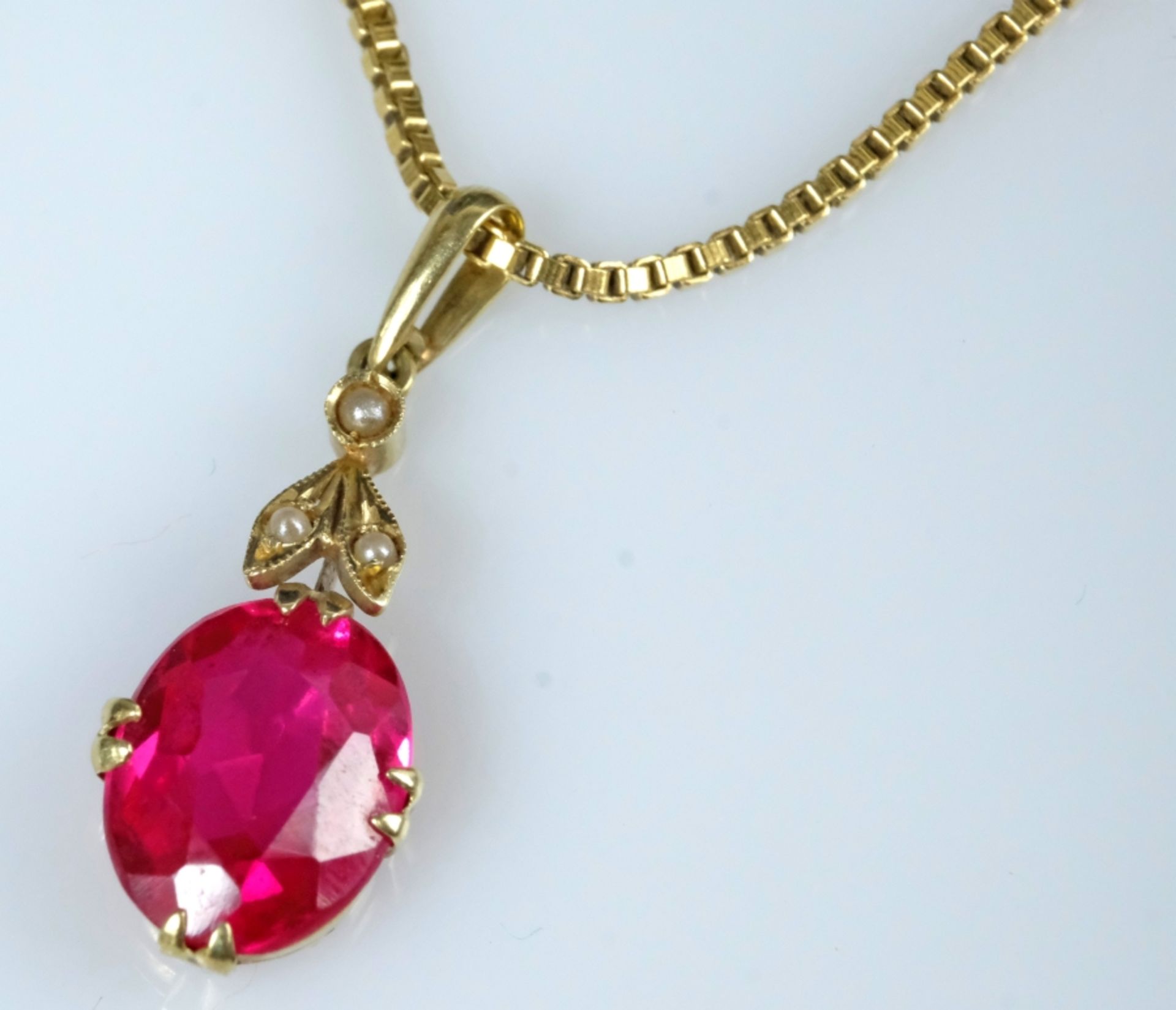 Ruby pendant on a fine gold chain, ruby set in eight fine prongs, setting with three small pearls.  - Image 3 of 4