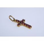 Small cross pendant, set with small garnet stones in prong setting, length 2 cm, silver 900 setting