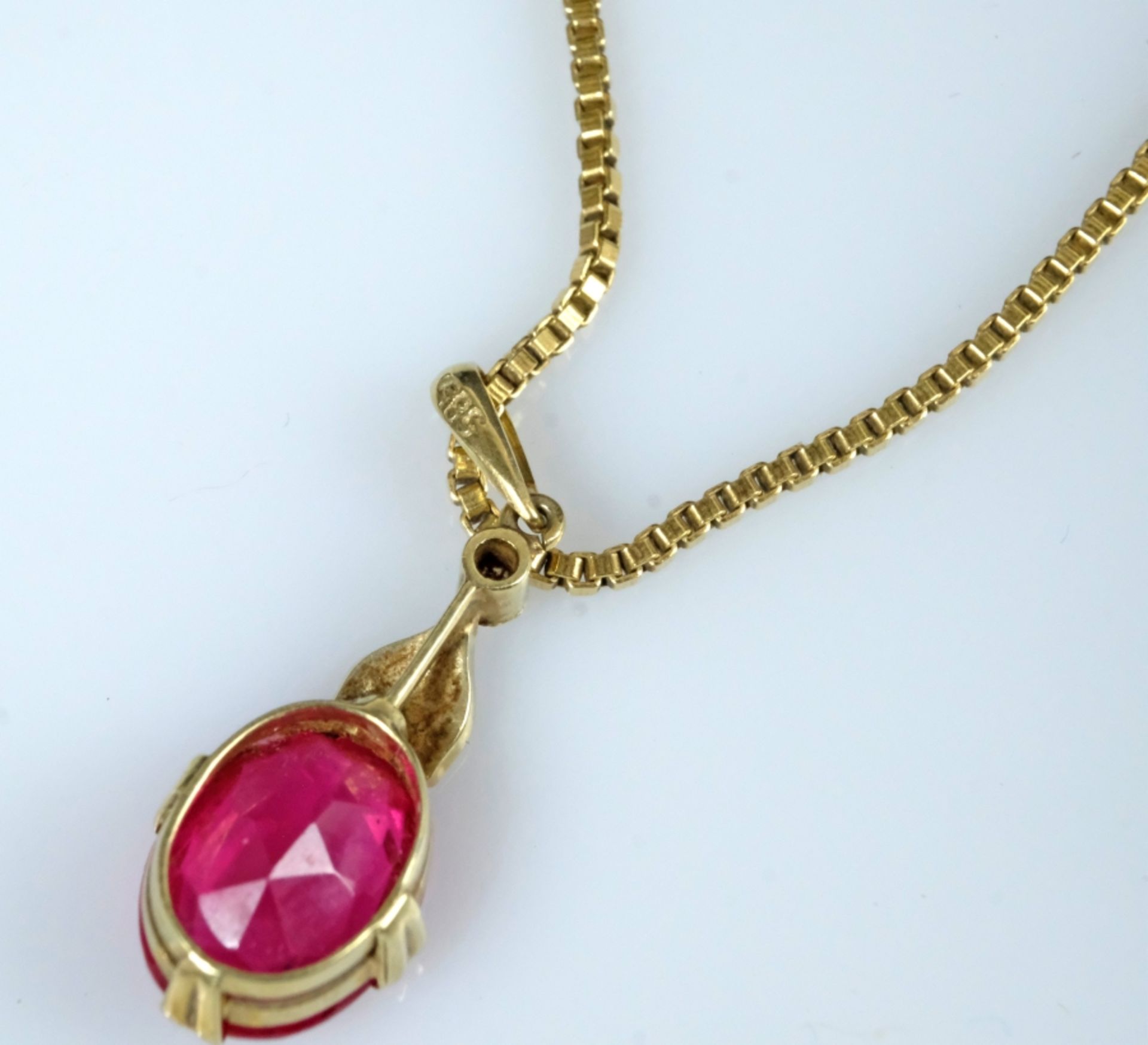 Ruby pendant on a fine gold chain, ruby set in eight fine prongs, setting with three small pearls.  - Image 4 of 4