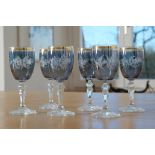 Six wine glasses, blue with gold rim, hexagonal cut stems, matt cut decoration, leaves, flowers and