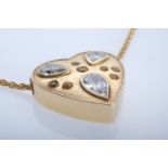 An antique heart pendant set with three old-cut diamonds, white, with inclusions, and seven citrine