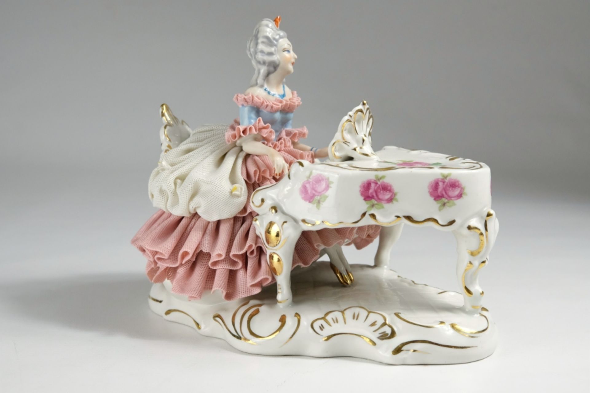 Porcelain figure, lady with a sweeping tulle dress on a wing, painted with roses.  - Image 2 of 5