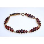 Bracelet consisting of seven bars, each set with five differently sized garnets in a beautiful dark