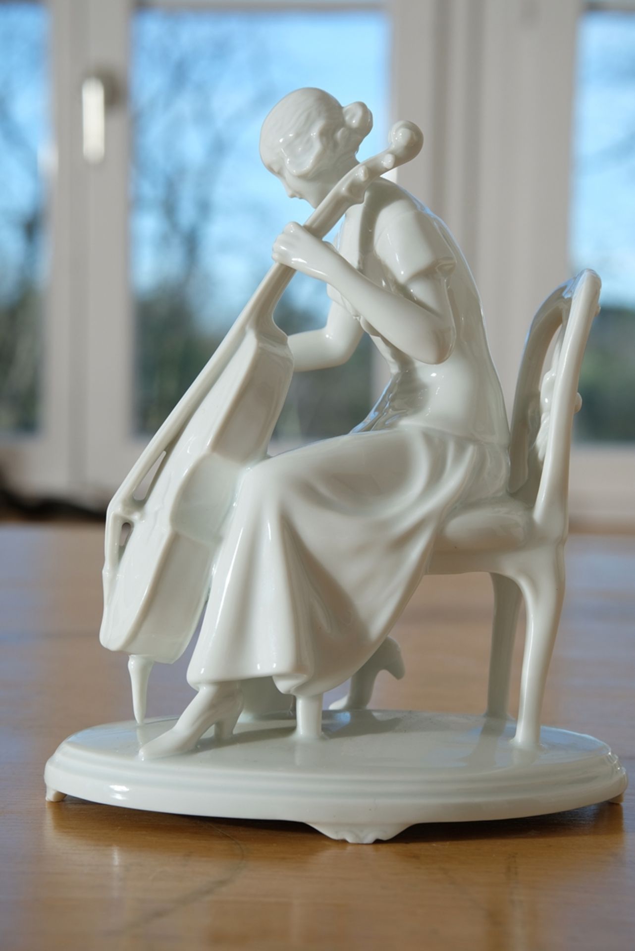 Porcelain figure Cello player, Augarten Vienna, cello bow missing, 20 cm high