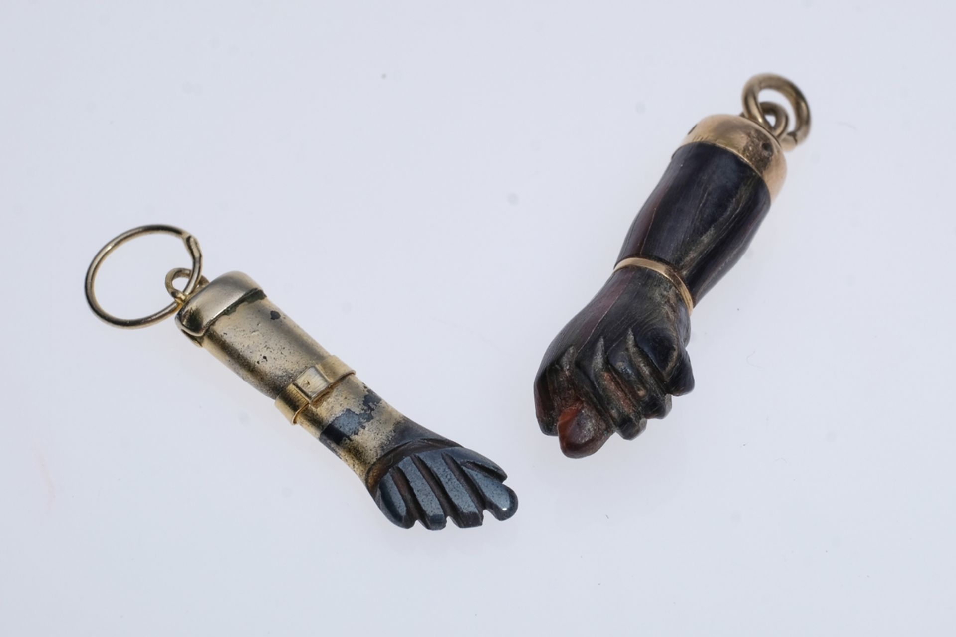 Figa made of ebony and Figa made of coral or horn. 