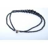 Necklace double-row, black faceted beads, D 5-15mm, pin fastener set with another bead, length 45cm