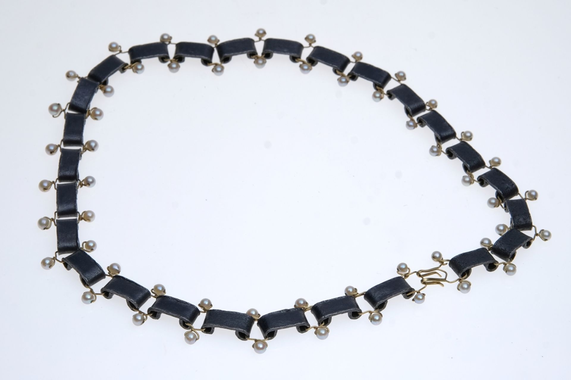 Design necklace, bent steel plates connected by gold-coloured rods, set with small pearls, length 2