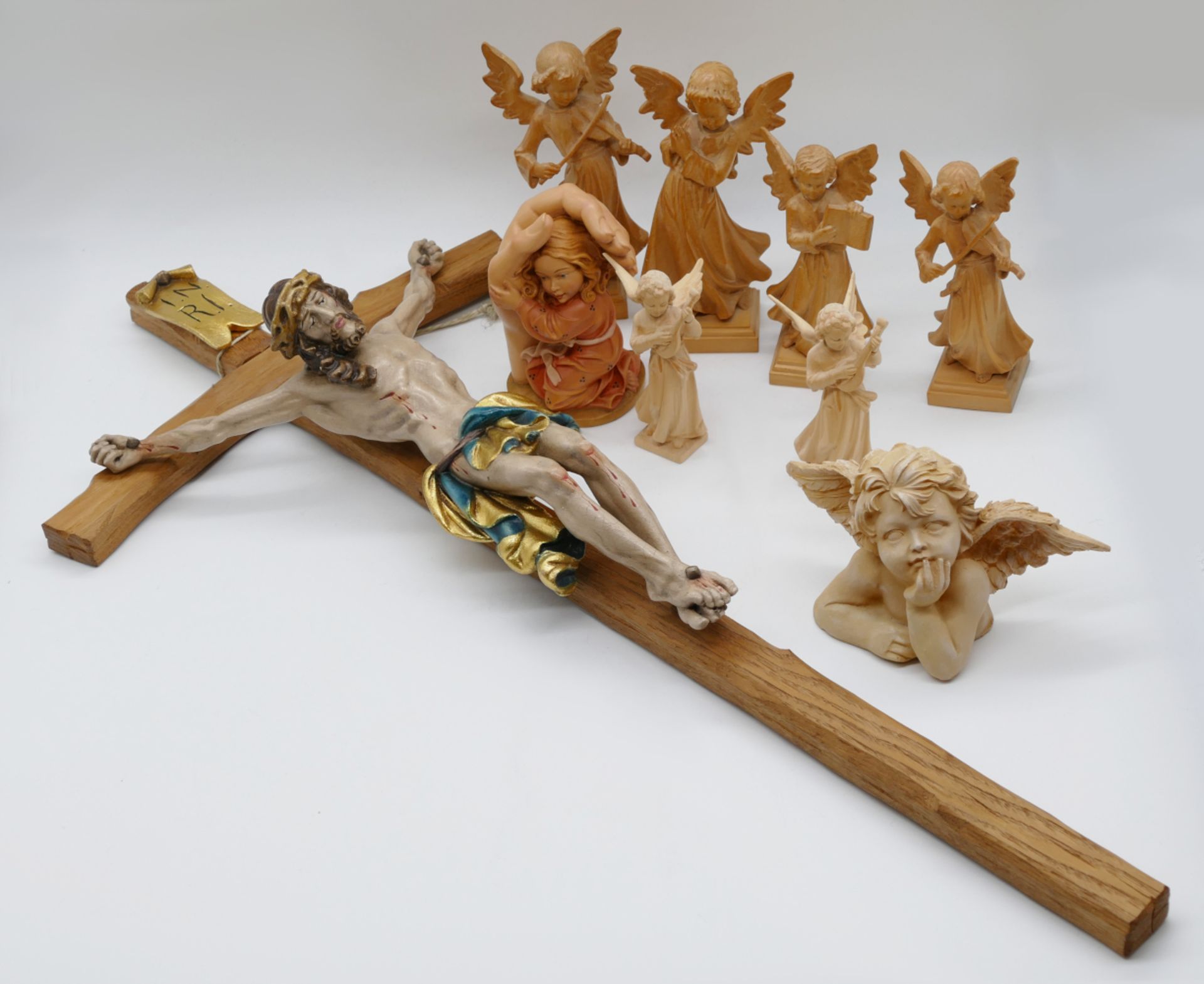 19 religiöse Figuren 20. Jh. Holz u.a., z.T. bemalt: "Kruzifix" ca. H 67cm, "Musizierender Putto" H