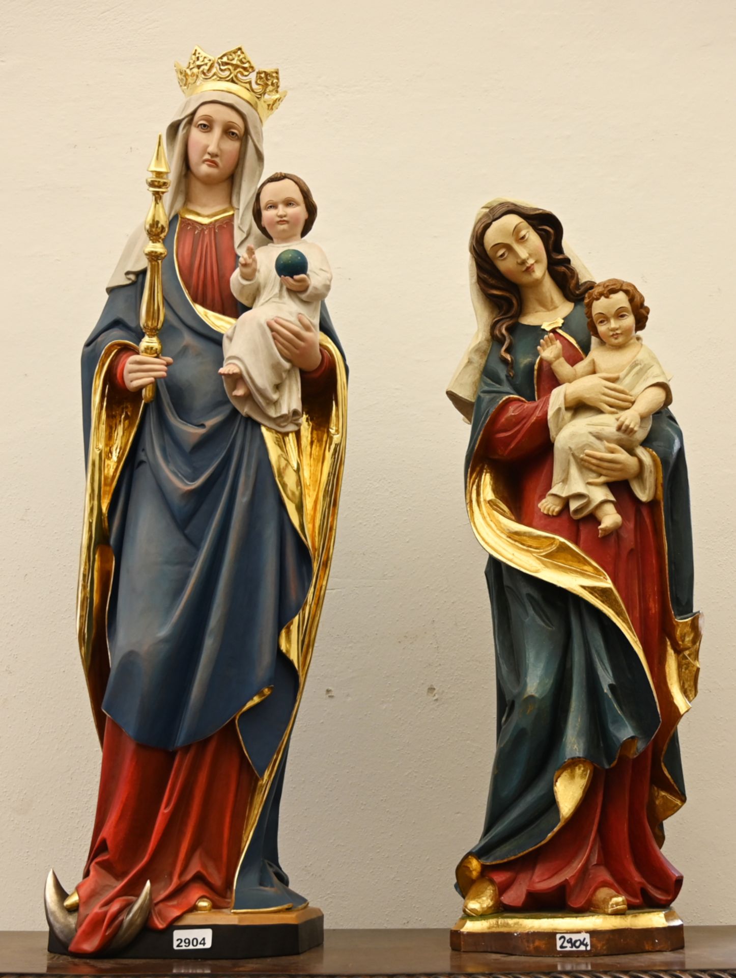 2 vollplastische Holzfiguren nztl., je Holz farbig gefasst/goldstaffiert: je "Madonna mit Kind", 1x