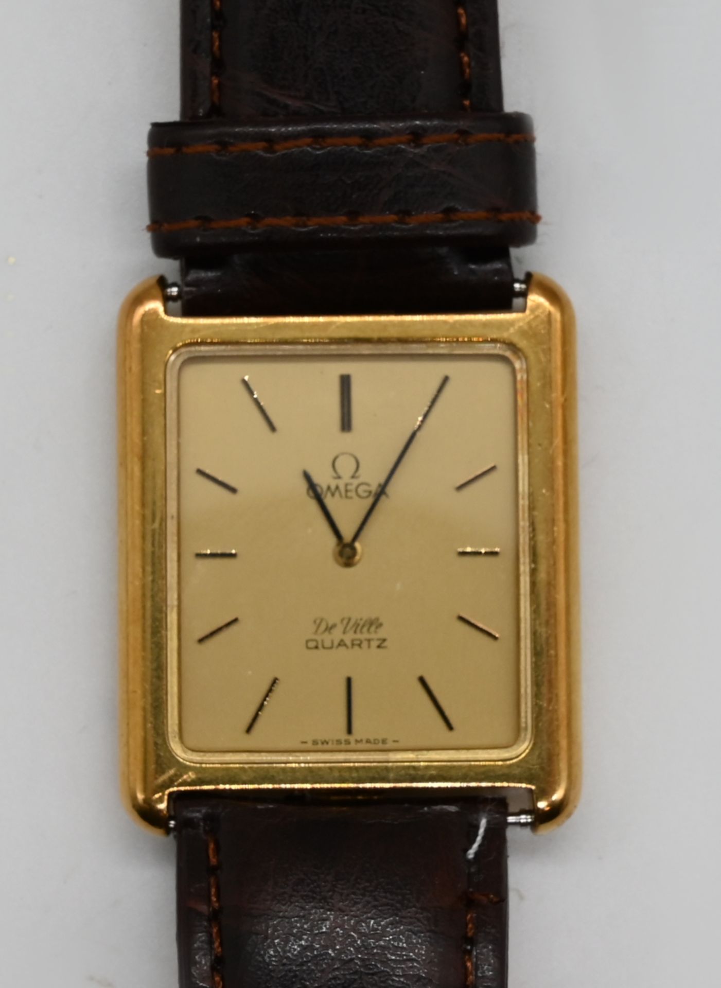 1 Herrenarmanduhr OMEGA "De Ville" Quarz, Gehäuse GG 18ct., Band ersetzt, vergoldete Originalschließ