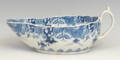 A Worcester Donut Tree pattern sauce boat, decorated in underglaze blue with stylised trees and