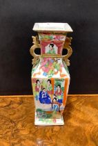 A Chinese famille rose slab sided vase, painted in the typical Cantonese manner with figures of