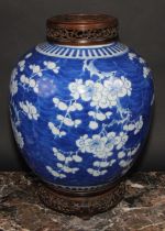 A large Chinese ovoid ginger jar, painted in tones of underglaze blue with blossoming prunus on a