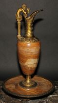 A 19th century Grecian Revival gilt metal and onyx ewer, the lofty handle crested by a Bacchic