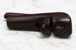 Nutcrackers - a 19th century novelty lever-action nut cracker, naively carved as a face, 14cm long