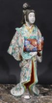 A Japanese porcelain figure, of a lady in a kimono, 46cm high, Meiji period