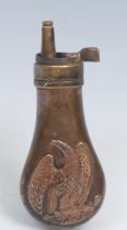 A copper and brass pistol powder flask, in the manner of Remington, embossed with an American