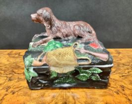 A Vallerysthal pressed glass novelty box and cover, surmounted by a hunting dog, game bag and gun,