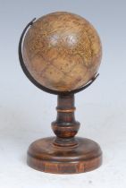 A 19th century miniature terrestrial globe, The Earth, published by J G Klinger, Nuremberg, the