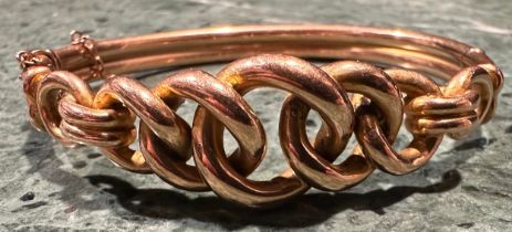 A gold coloured metal hollow cast hinged bangle, five interlinked graduated curb links, stamped '