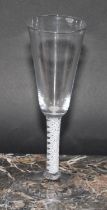 A George III opaque twist wine glass, funnel shaped bowl, double helix stem, domed circular foot,
