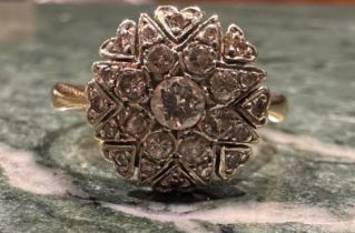 A diamond cluster ring, eight point star and heart crest set with twenty five round old brilliant