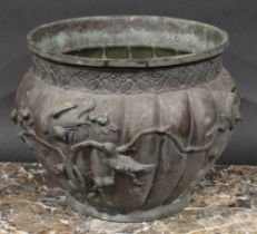A Japanese bronzed metal jardiniere, cast and applied with birds and fruiting branches, 21.5cm high,