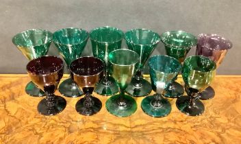 A 19th century emerald green coloured drinking glass, faceted trumpet shaped bowl, knopped stem,