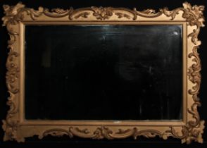 A Rococo Revival giltwood and gesso chimney glass, rectangular mirror plate, the frame applied