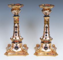 A pair of Royal Crown Derby Imari palette 1128 pattern Castleton candlesticks, shaped square bases