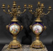 A pair of 19th century gilt metal and porcelain six light candelabra, acanthus scroll branches,