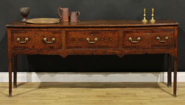 A George III mahogany crossbanded oak low dresser, slightly oversailing top above three frieze