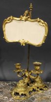 A 19th century ormolu combination study lamp and standish, with cartouche shaped shade and a pair of