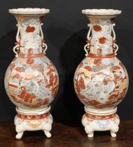 A pair of Japanese Satsuma ovoid vases and stands, typically painted with figures and traditional