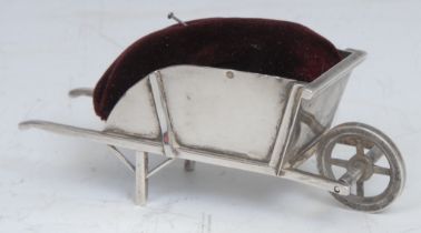 An early 20th century American silver novelty pin cushion, as a wheelbarrow, 9cm long, marked