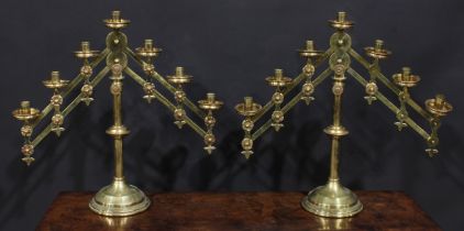 A pair of 19th century Gothic Revival brass adjustable ecclesiastical seven light candelabra, 51cm