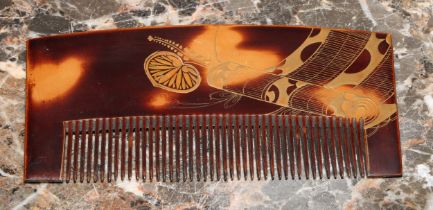 A Japanese faux tortoiseshell comb, decorated in gilt with a scroll and lotus leaves, 12.5cm wide,