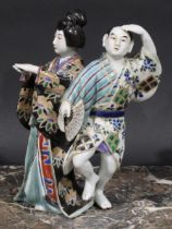 A Japanese porcelain figure group, a geisha and a man holding a fan, 22cm high, early 20th century