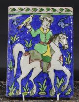 A Middle Eastern rectangular tile or panel, moulded and decorated in the Qajar manner with a