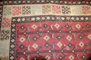 A Turkish Sarkoy Kilim rug or carpet, worked in the traditional manner, 339cm x 261cm