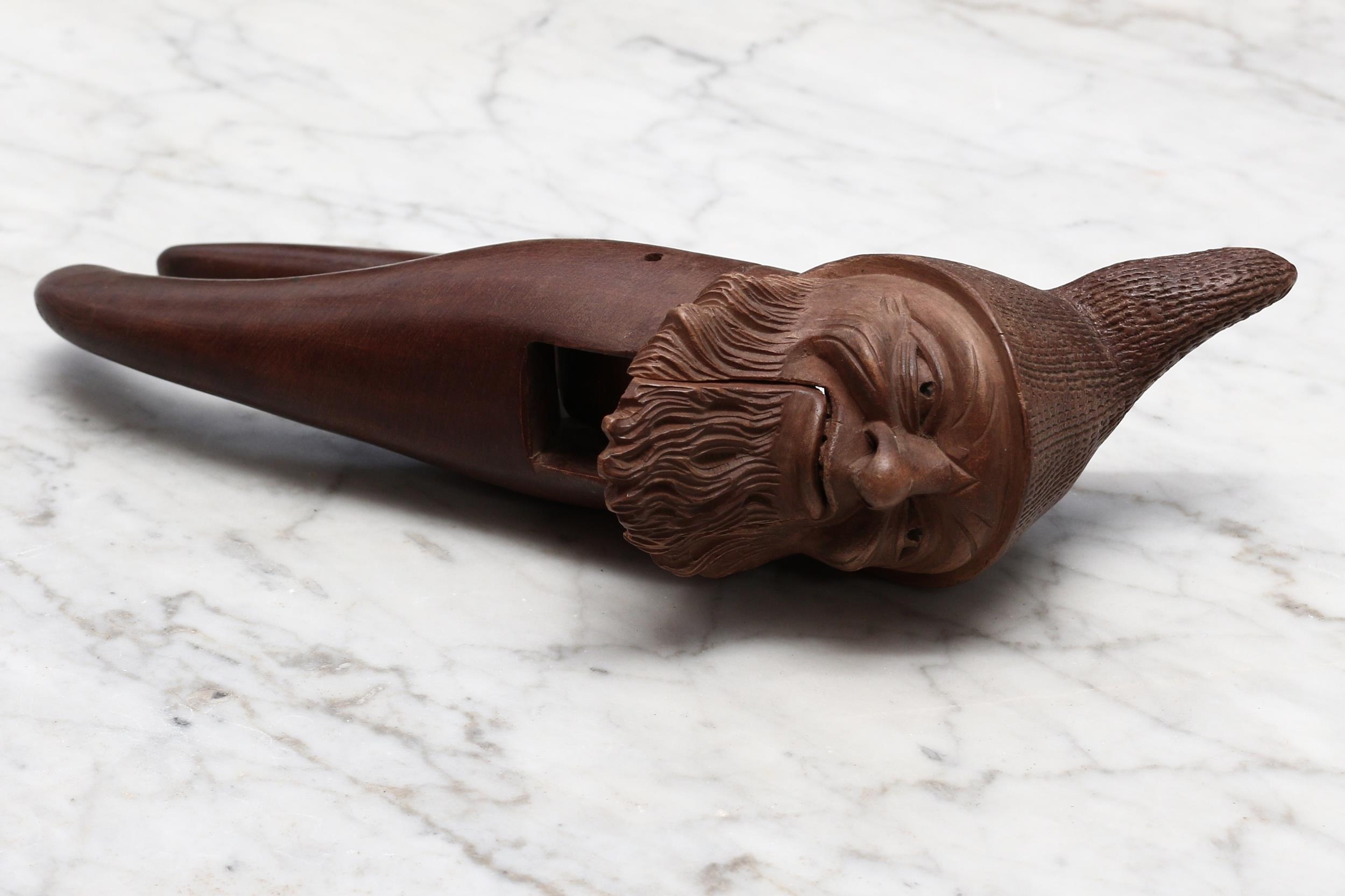 Nutcrackers - a Black Forest novelty lever-action nut cracker, carved as the head of a bearded