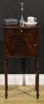 A 19th century mahogany bedroom cabinet, flame-veneered top above a drawer and door, turned legs,