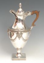 A George III Neo-Classical silver pedestal wine ewer, hinged cover with acaorn finial, chased with