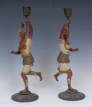 A pair of Continental cold painted spelter figural candlesticks, each cast in the Orientalist
