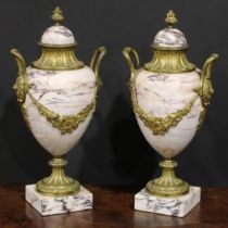 A pair of Louis XVI Revival gilt metal mounted marble pedestal ovoid urns, 46cm high, early 20th