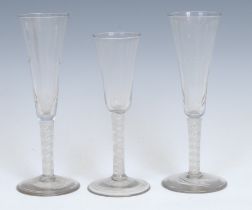 A pair of George III opaque twist ale glasses, each with fluted conical bowl, double-helix stem, and