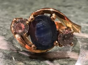 A blue and white sapphire ring, twisted crest with central oval deep blue sapphire approx 1.50ct