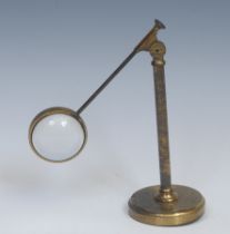 An early 20th century lacquered brass adjustable desk top magnifier, convex specimen lens,