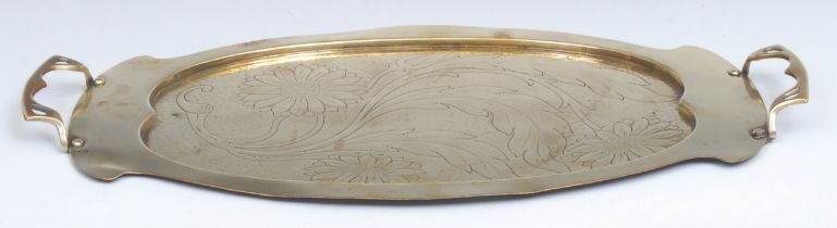 An Arts and Crafts brass shaped oval two-handled serving tray, the field embossed with stylised