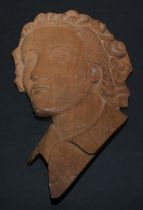 An Art Deco carved beech portrait wall plaque, depicting a young lady, bust length, 26cm long,